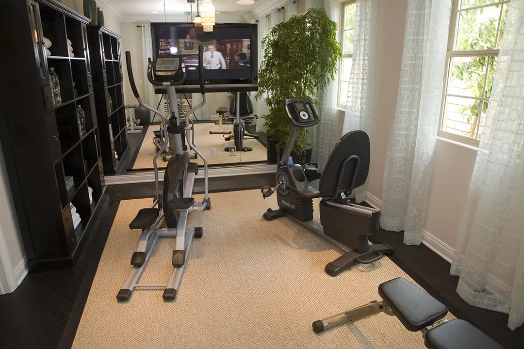 Exercise equipment in home gym in front of mirror