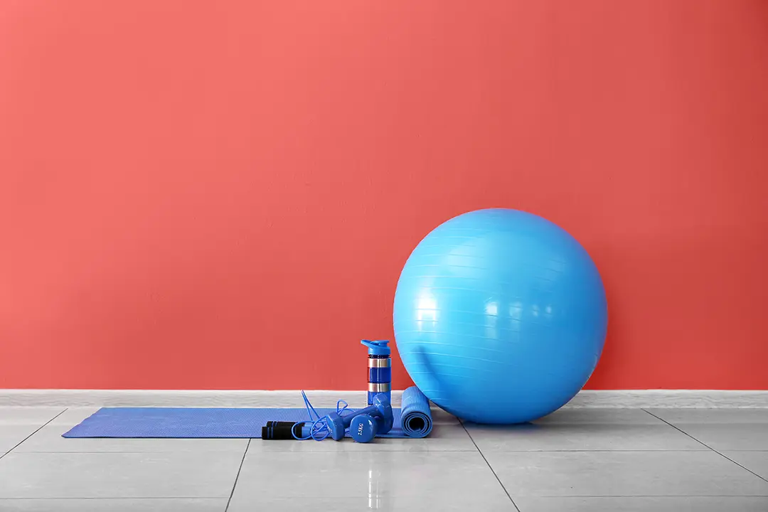 Bright blue exercise equipment in front of red wall