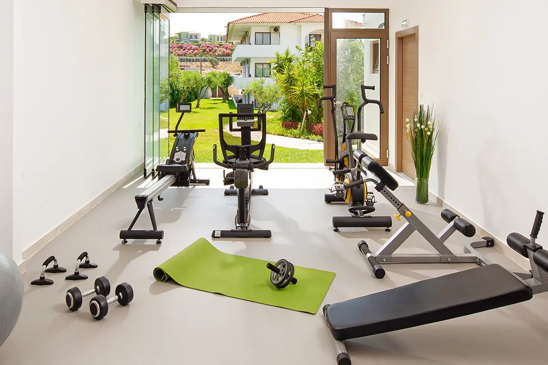 Exercise equipment in home gym with outdoor access